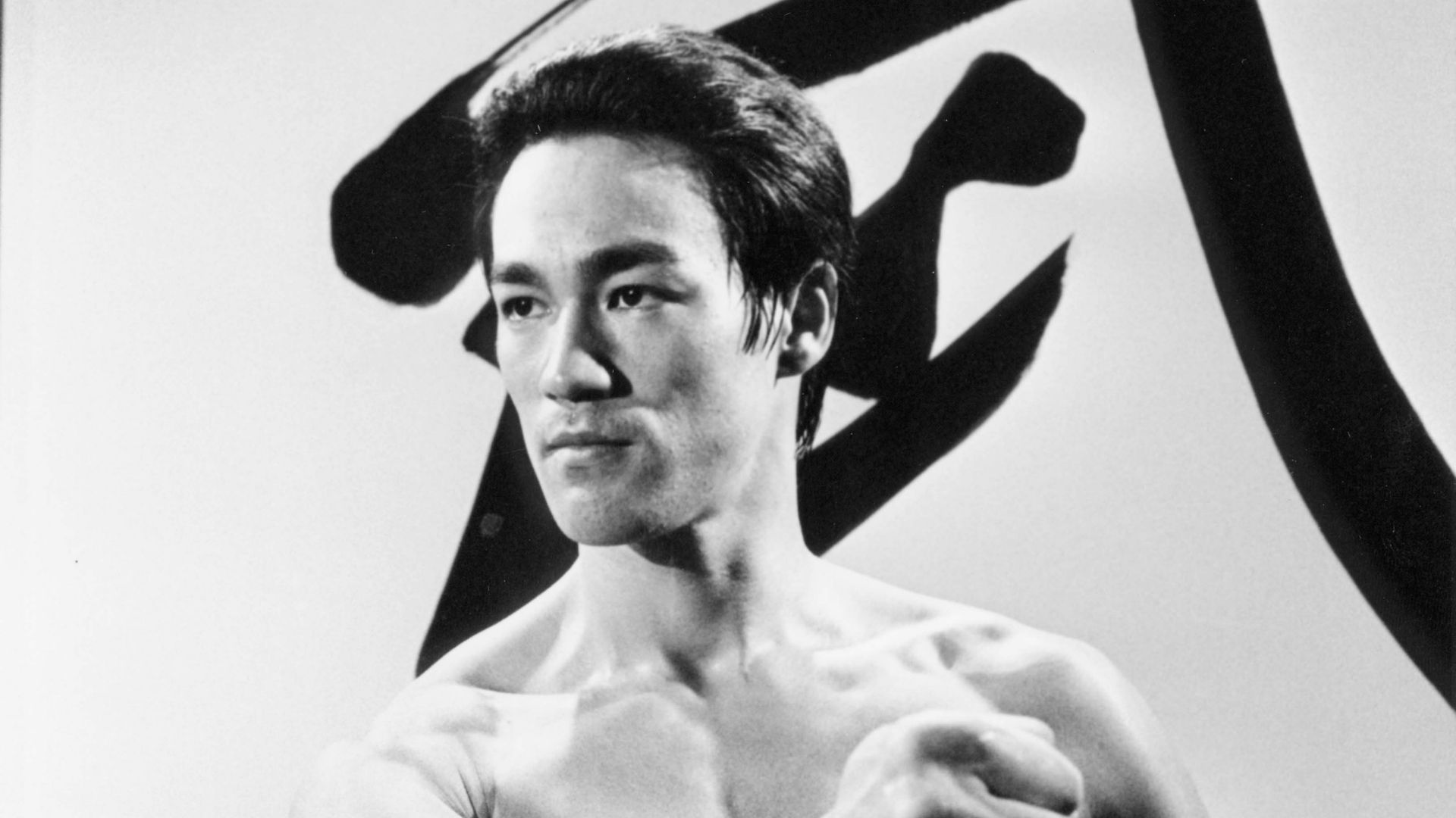 Black and white photo with man in martial arts pose.